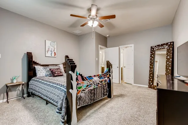 a bed room with furniture and a flat screen tv