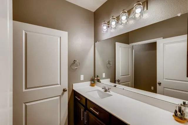 a bathroom with a sink vanity and a mirror