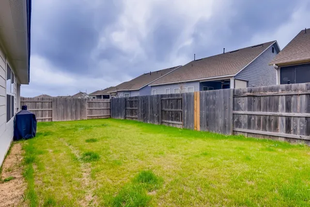 a view of a house with a backyard and a patio