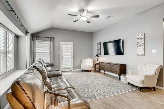 a bedroom with furniture and a flat screen tv
