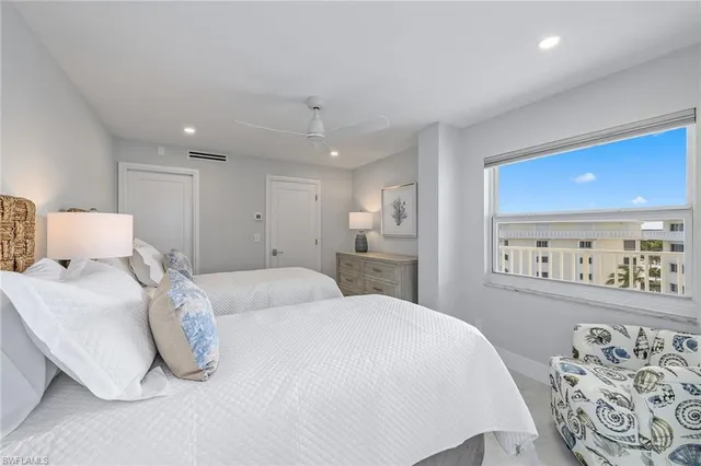 a spacious bedroom with a bed and a lamp