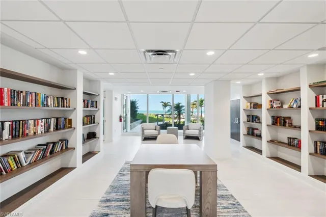 a living room with furniture and a book shelf