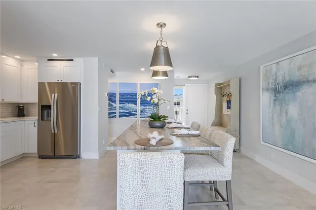 a dining room with furniture a window and kitchen view