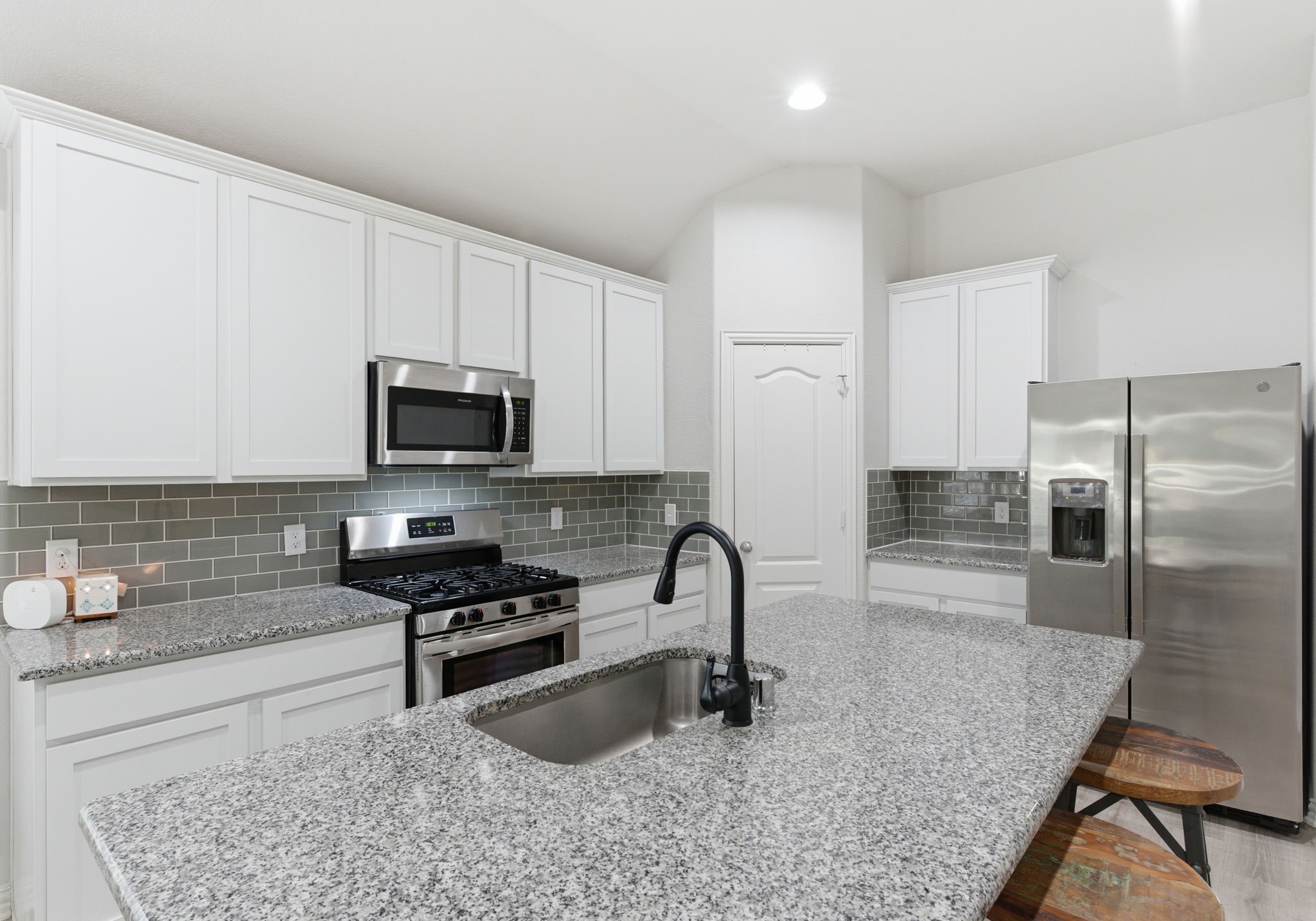 27146 Grey Fox Run Magnolia, TX 77354 - Photo 14 of 44 a kitchen with stainless steel appliances granite countertop a sink a stove and cabinets