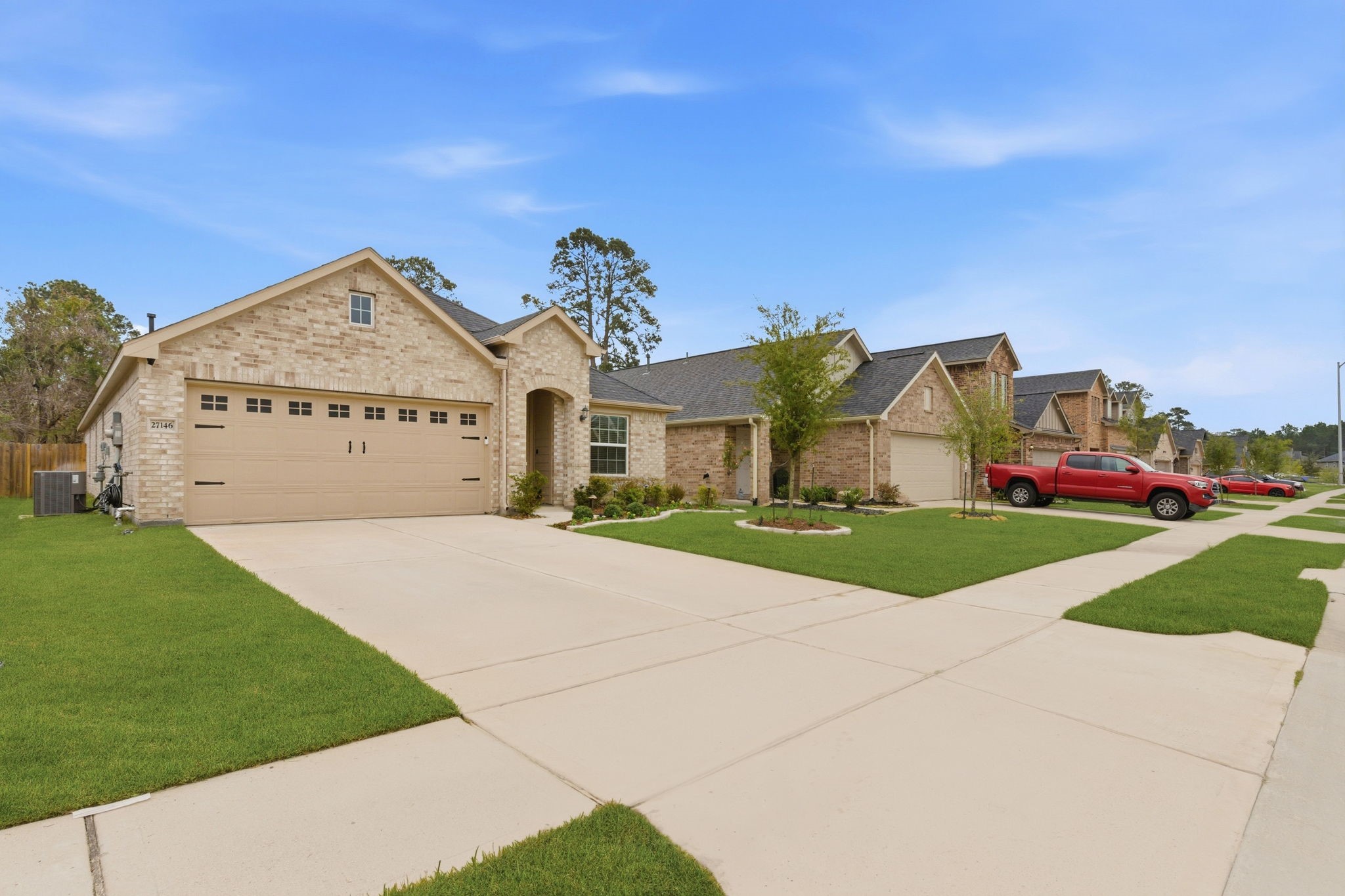 27146 Grey Fox Run Magnolia, TX 77354 - Photo 4 of 44 a front view of a house with a yard and garage