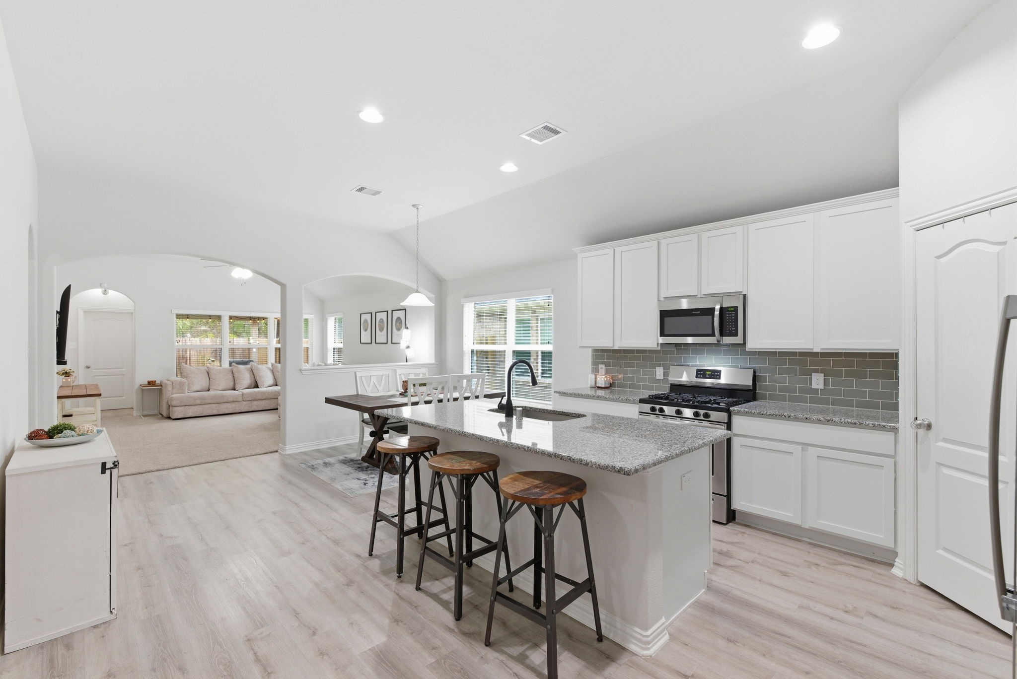 27146 Grey Fox Run Magnolia, TX 77354 - Photo 9 of 44 a kitchen with stainless steel appliances a table and chairs in it