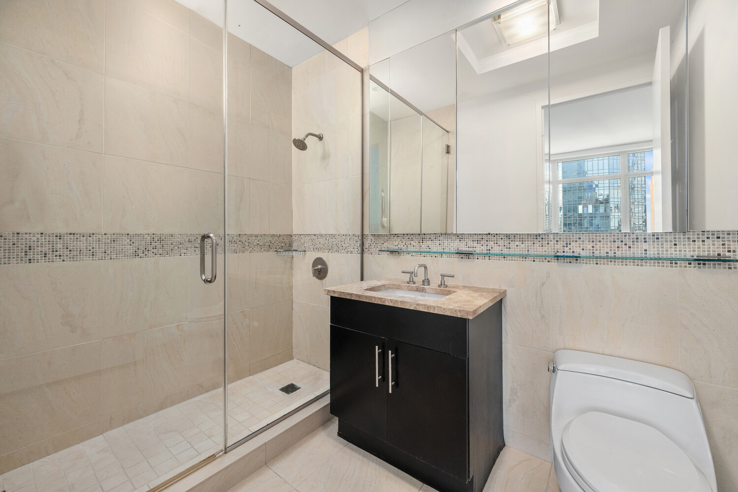 325 5th Avenue, Unit 39C Manhattan, NY 10016 - Photo 10 of 19 a bathroom with a granite countertop sink toilet and shower