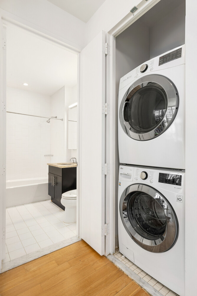 325 5th Avenue, Unit 39C Manhattan, NY 10016 - Photo 7 of 19 a utility room with dryer and washer