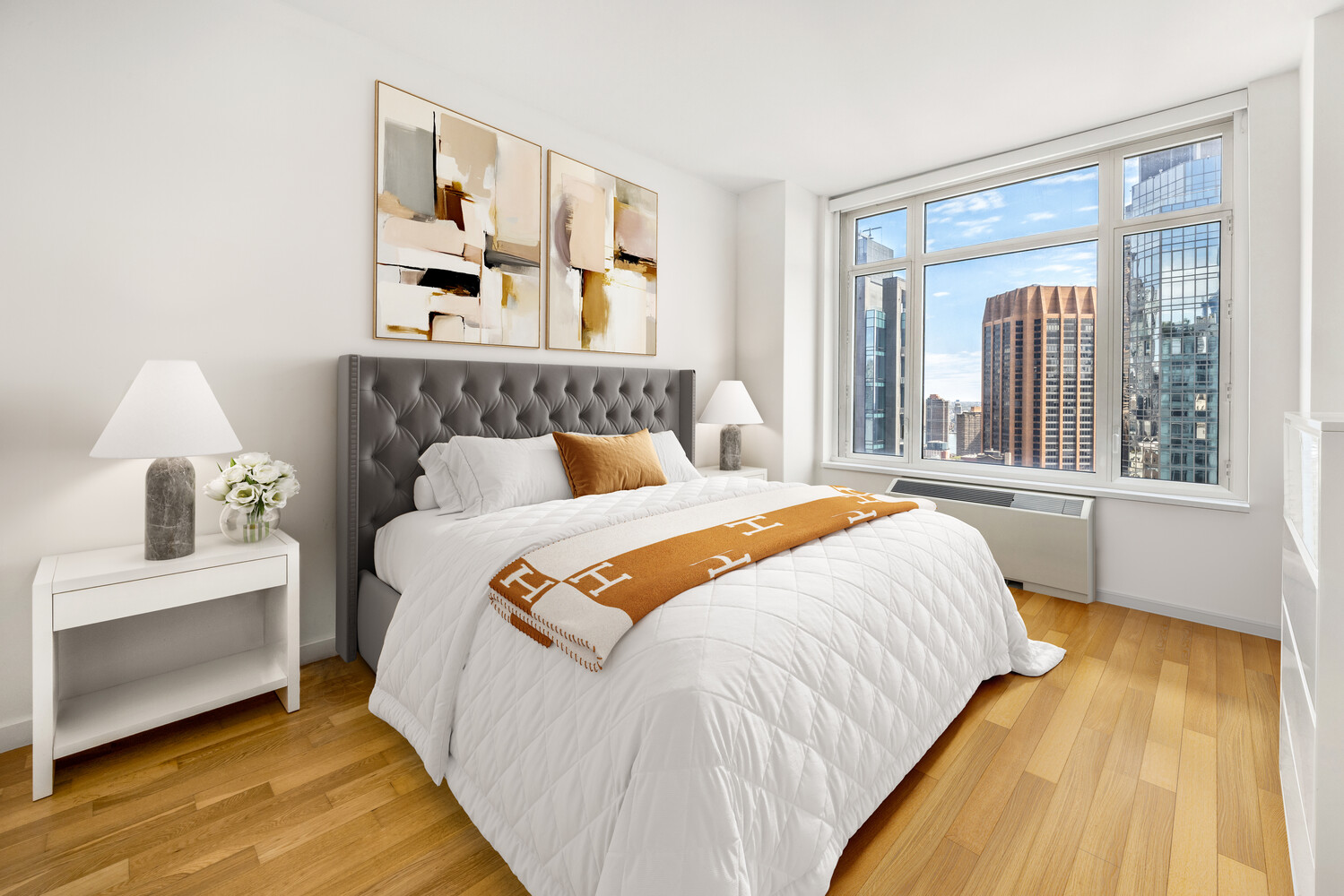 325 5th Avenue, Unit 39C Manhattan, NY 10016 - Photo 9 of 19 a bed sitting in a bedroom next to a window