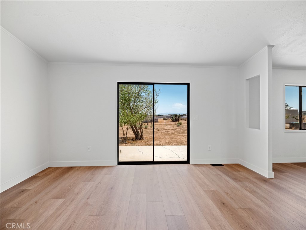 10139 Sonora Road Phelan, CA 92371 - Photo 12 of 37 wooden floor in an empty room with a window