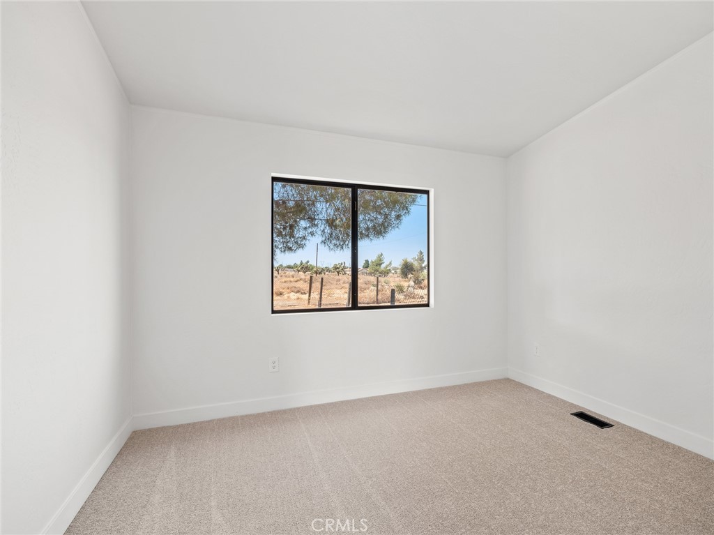 10139 Sonora Road Phelan, CA 92371 - Photo 16 of 37 an empty room with a window
