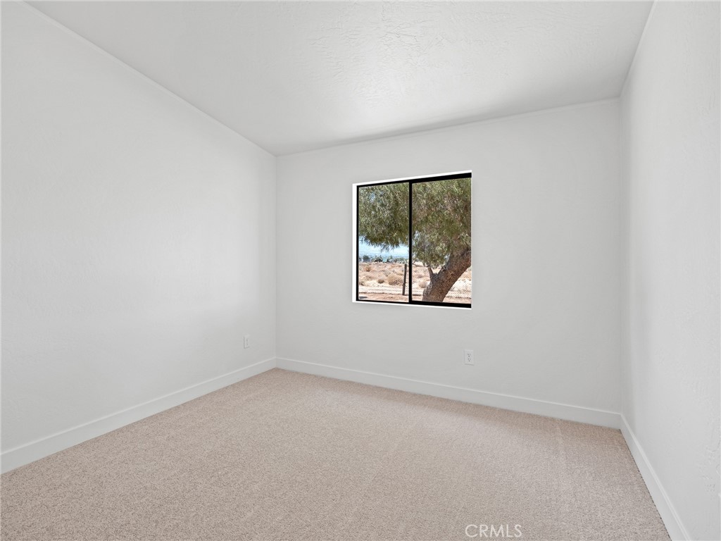 10139 Sonora Road Phelan, CA 92371 - Photo 19 of 37 an empty room with a window