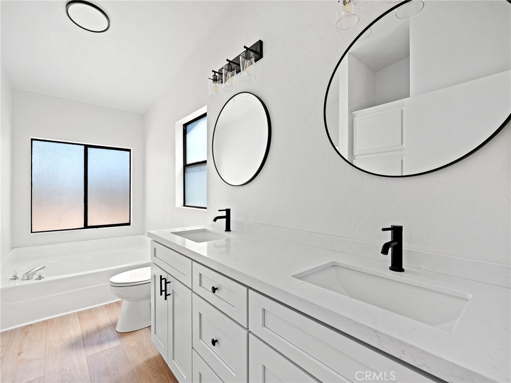 10139 Sonora Road Phelan, CA 92371 - Photo 24 of 37 a bathroom with a double vanity sink and a mirror