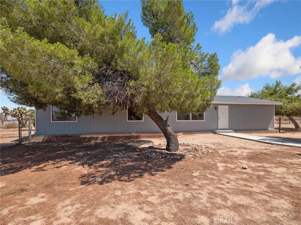 10139 Sonora Road Phelan, CA 92371 - Photo 32 of 37 a house with trees in front of it