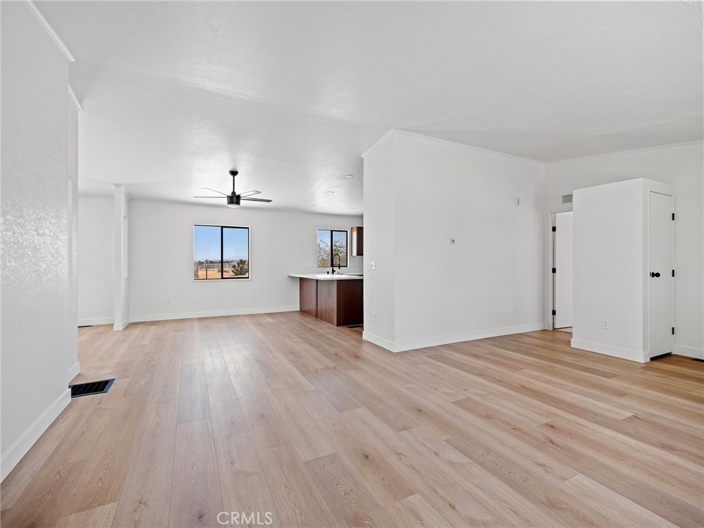10139 Sonora Road Phelan, CA 92371 - Photo 4 of 37 a view of empty room with wooden floor and window