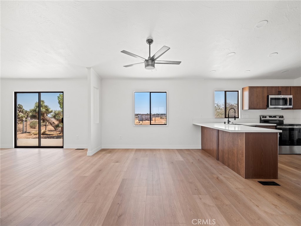 10139 Sonora Road Phelan, CA 92371 - Photo 6 of 37 a view of a kitchen with a sink and a stove top oven