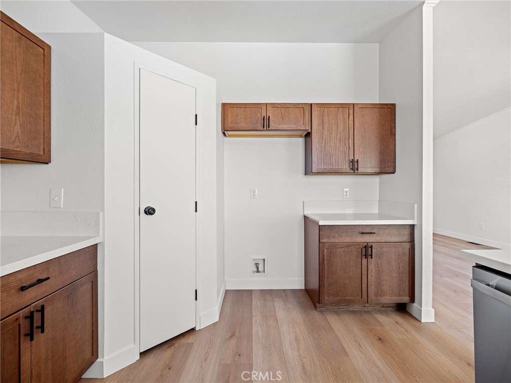 10139 Sonora Road Phelan, CA 92371 - Photo 9 of 37 a view of cabinets a wooden floor and a window in a room