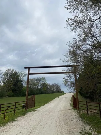 a view of a yard with wooden fence
