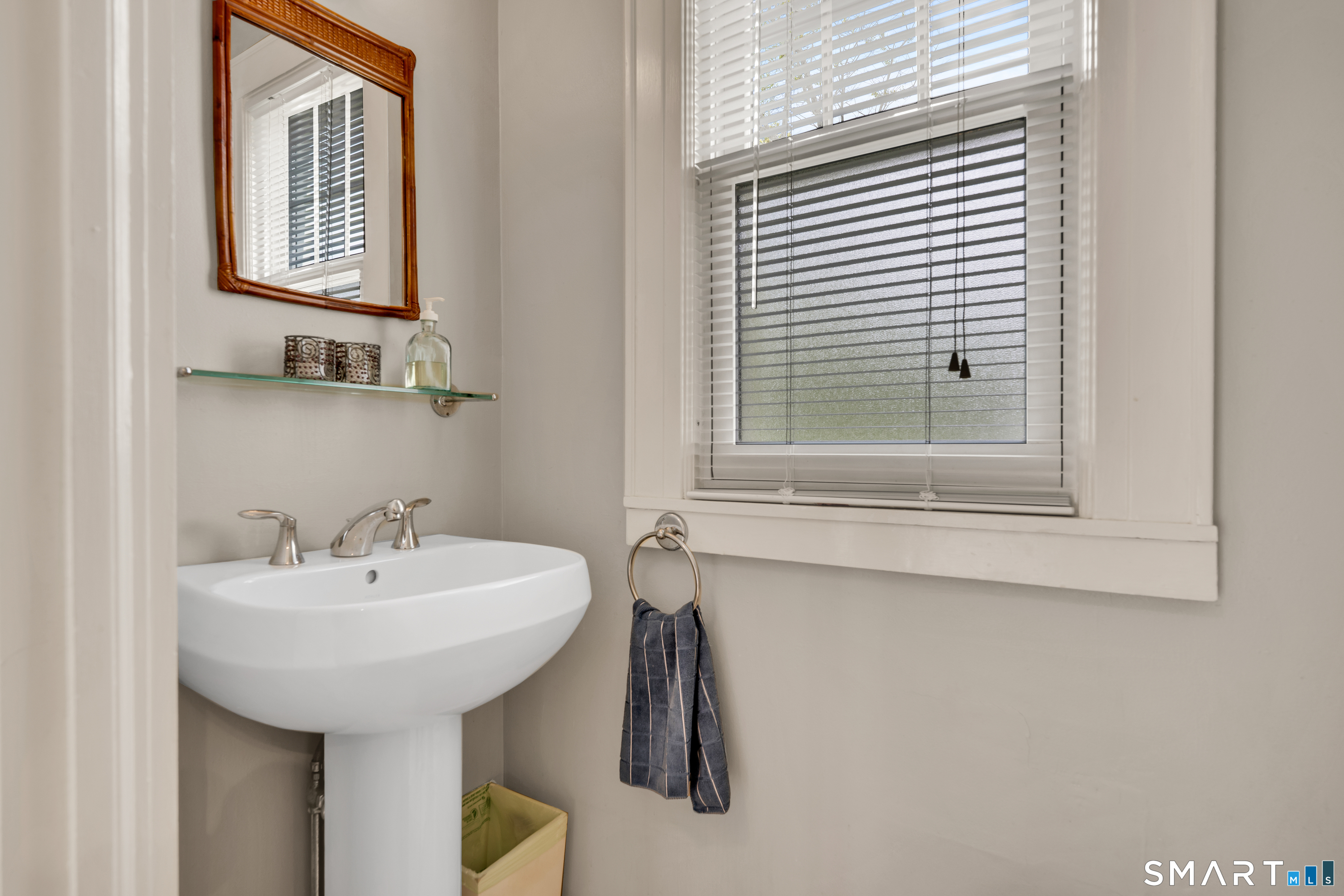44 Beverly Road Wethersfield, CT 06109 - Photo 22 of 31 a bathroom with a sink and a mirror