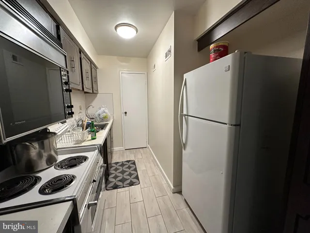 a kitchen with a refrigerator and a stove