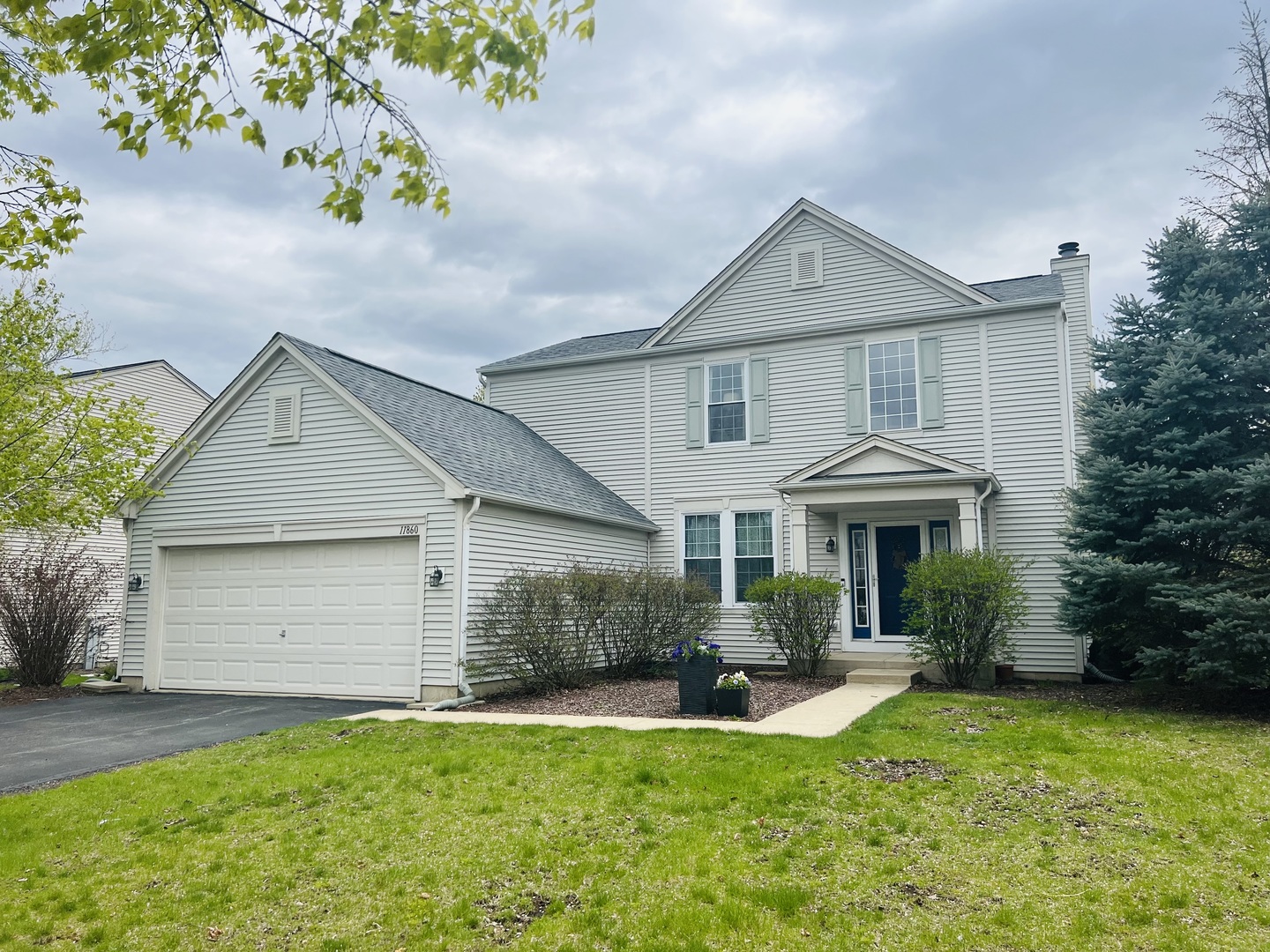 a front view of a house with a yard and garage