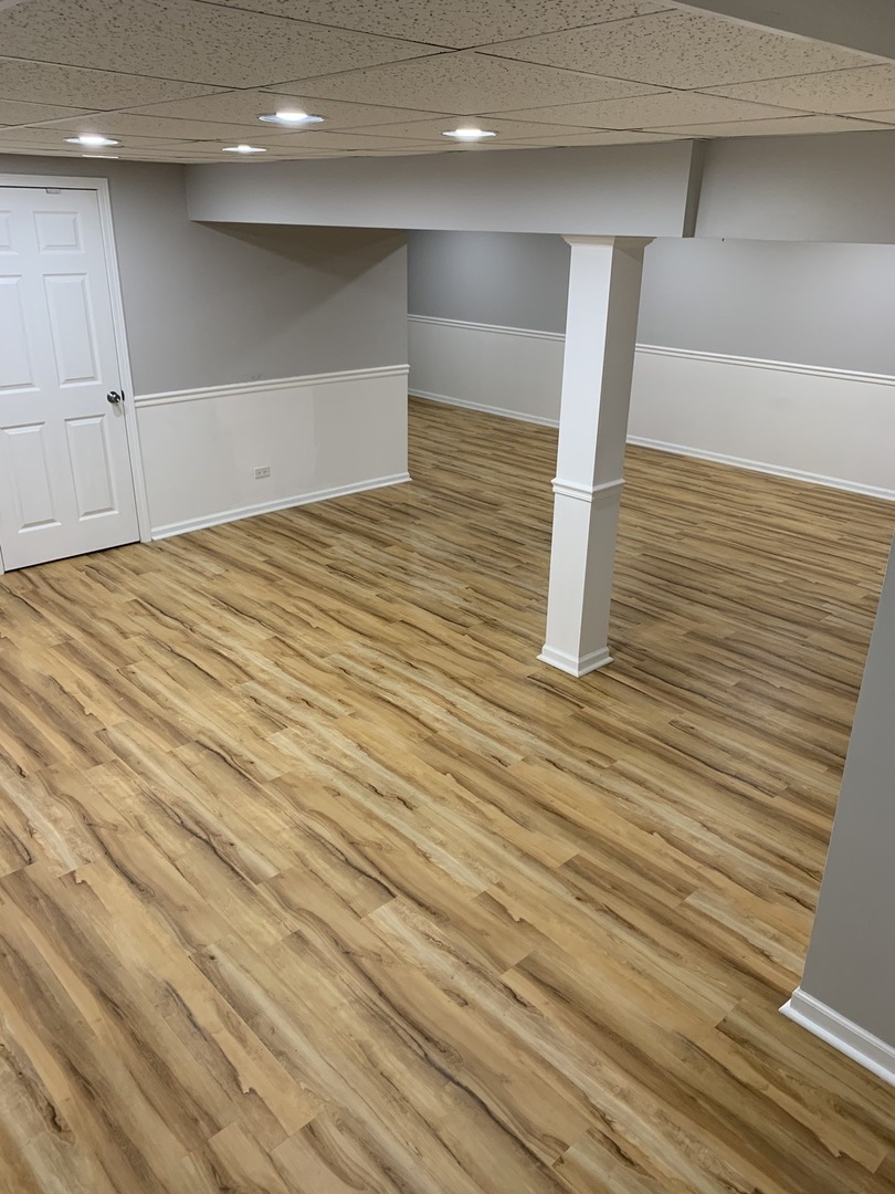 11860 Presley Circle Plainfield, IL 60585 - Photo 15 of 18 a view of a room with an empty space and wooden floor