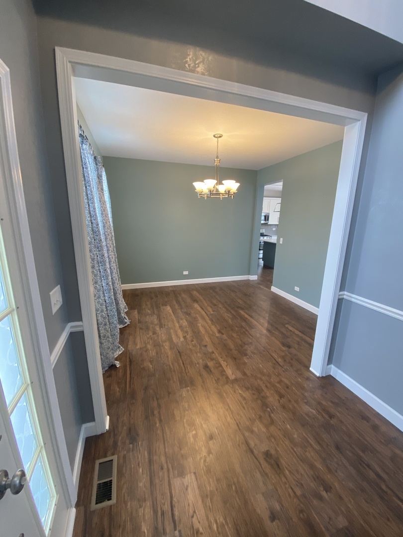 11860 Presley Circle Plainfield, IL 60585 - Photo 4 of 18 a view of a room with wooden floor and staircase