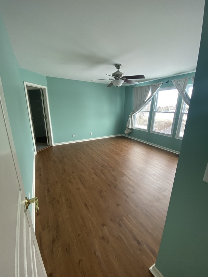 11860 Presley Circle Plainfield, IL 60585 - Photo 9 of 18 wooden floor in an empty room