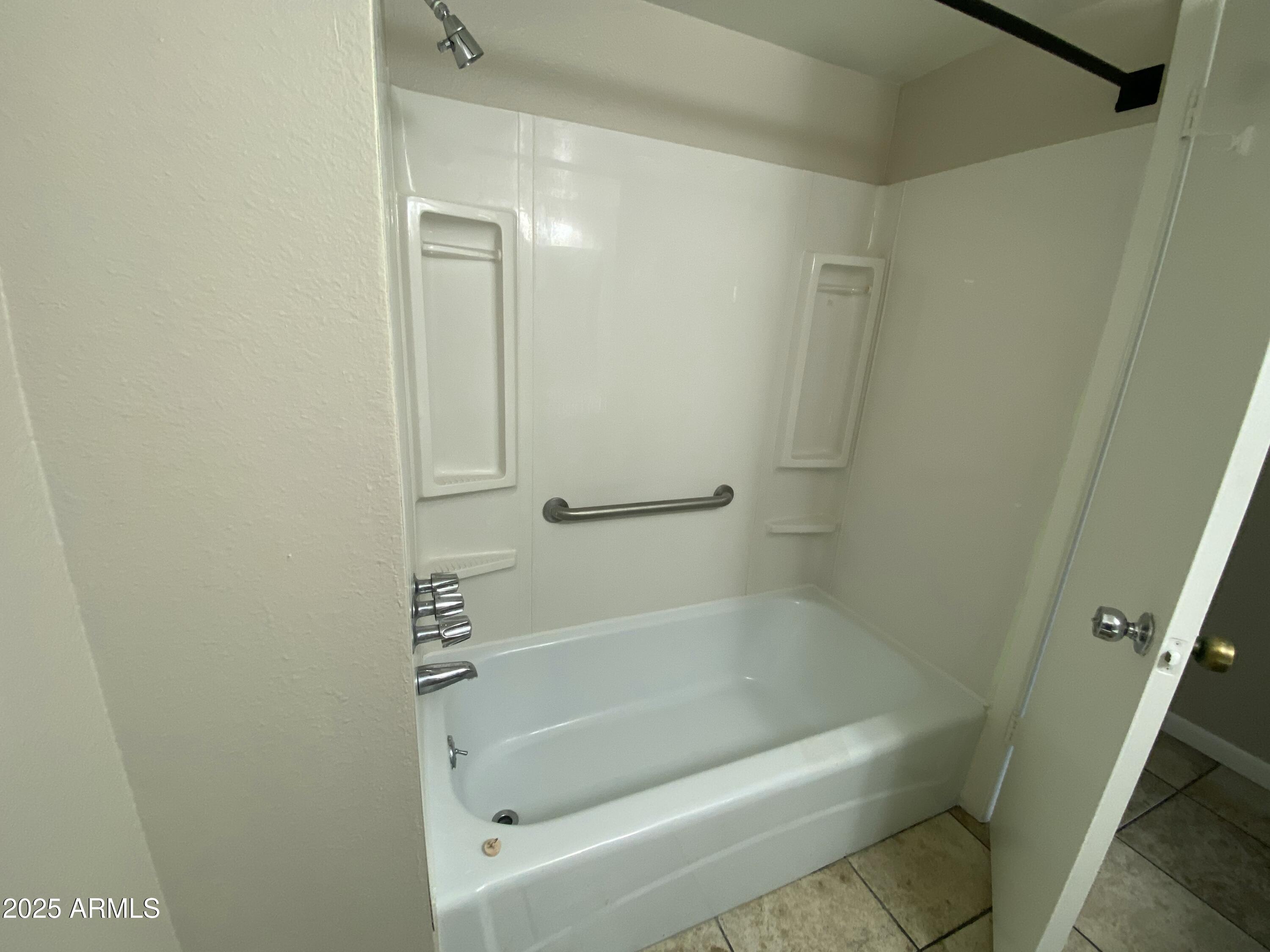 10417 North 95th Drive, Unit B Peoria, AZ 85345 - Photo 12 of 18 a bathroom with a bathtub