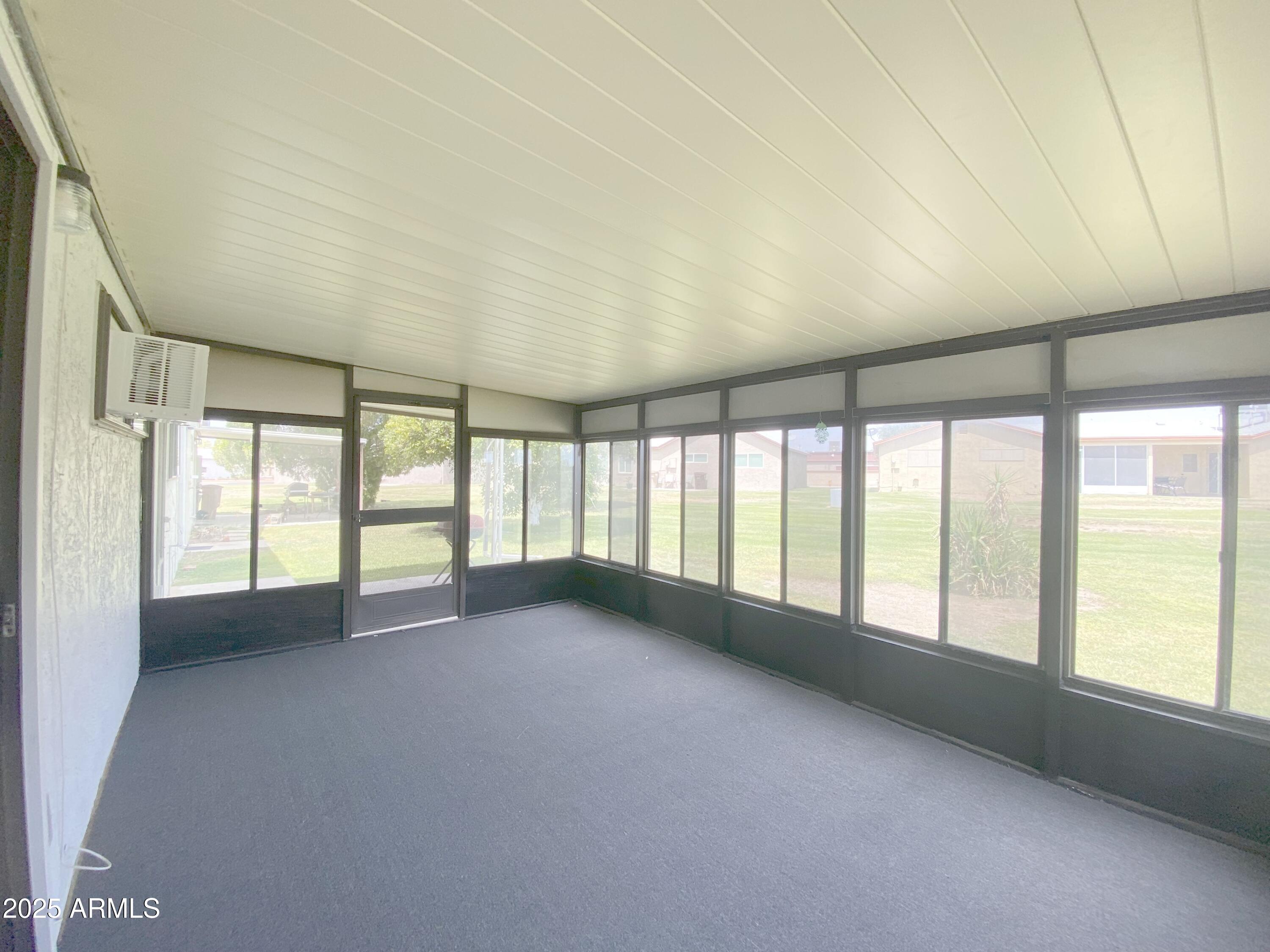 10417 North 95th Drive, Unit B Peoria, AZ 85345 - Photo 13 of 18 a view of an empty room with a window