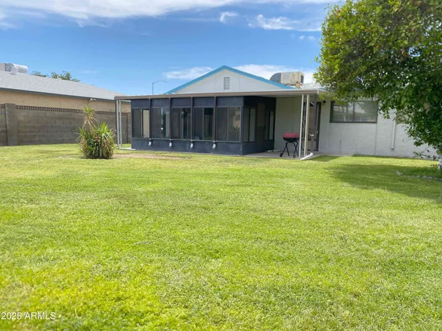 a view of a large pool with an outdoor space and seating area