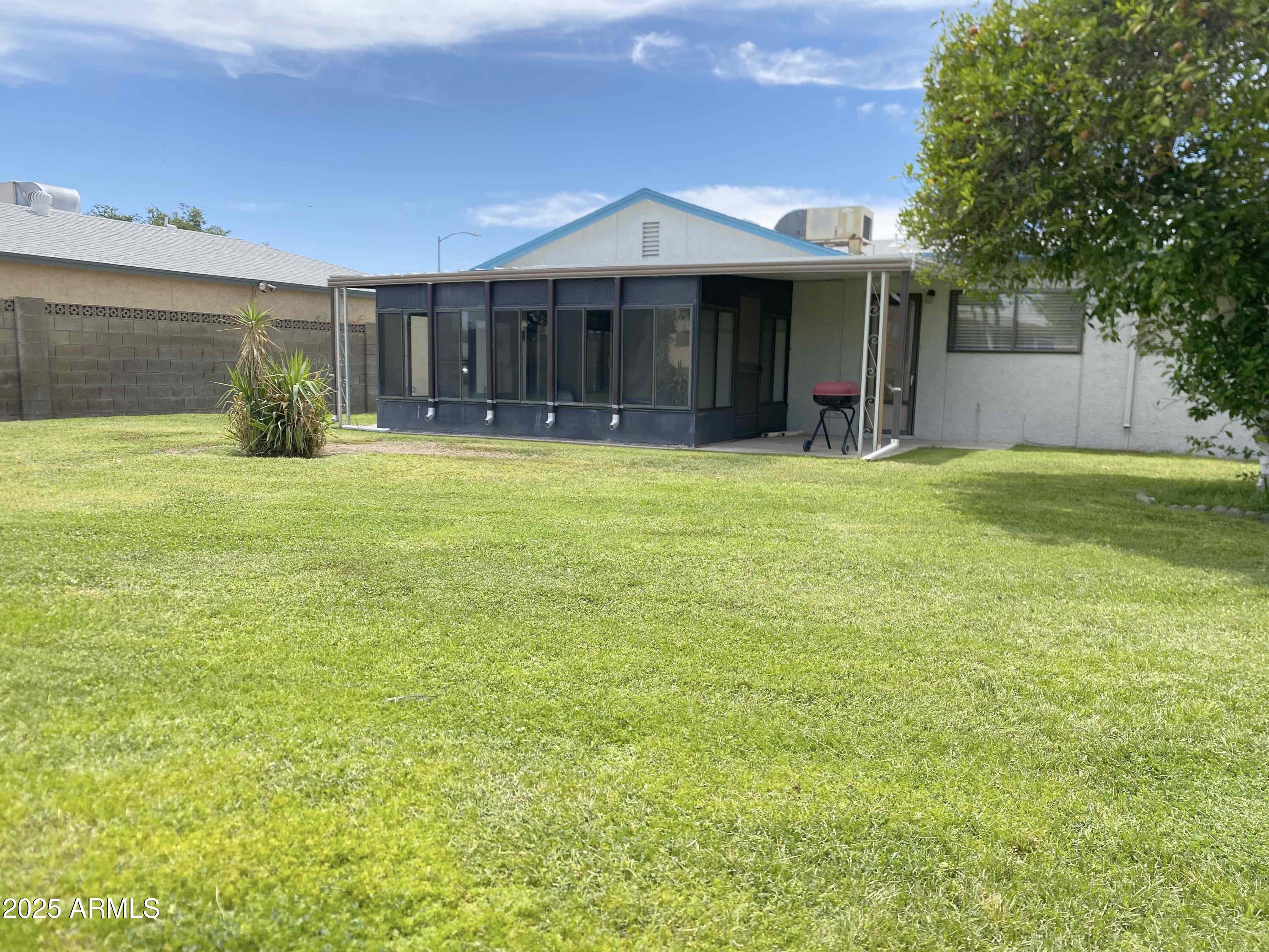 10417 North 95th Drive, Unit B Peoria, AZ 85345 - Photo 15 of 18 a front view of a house with a garden