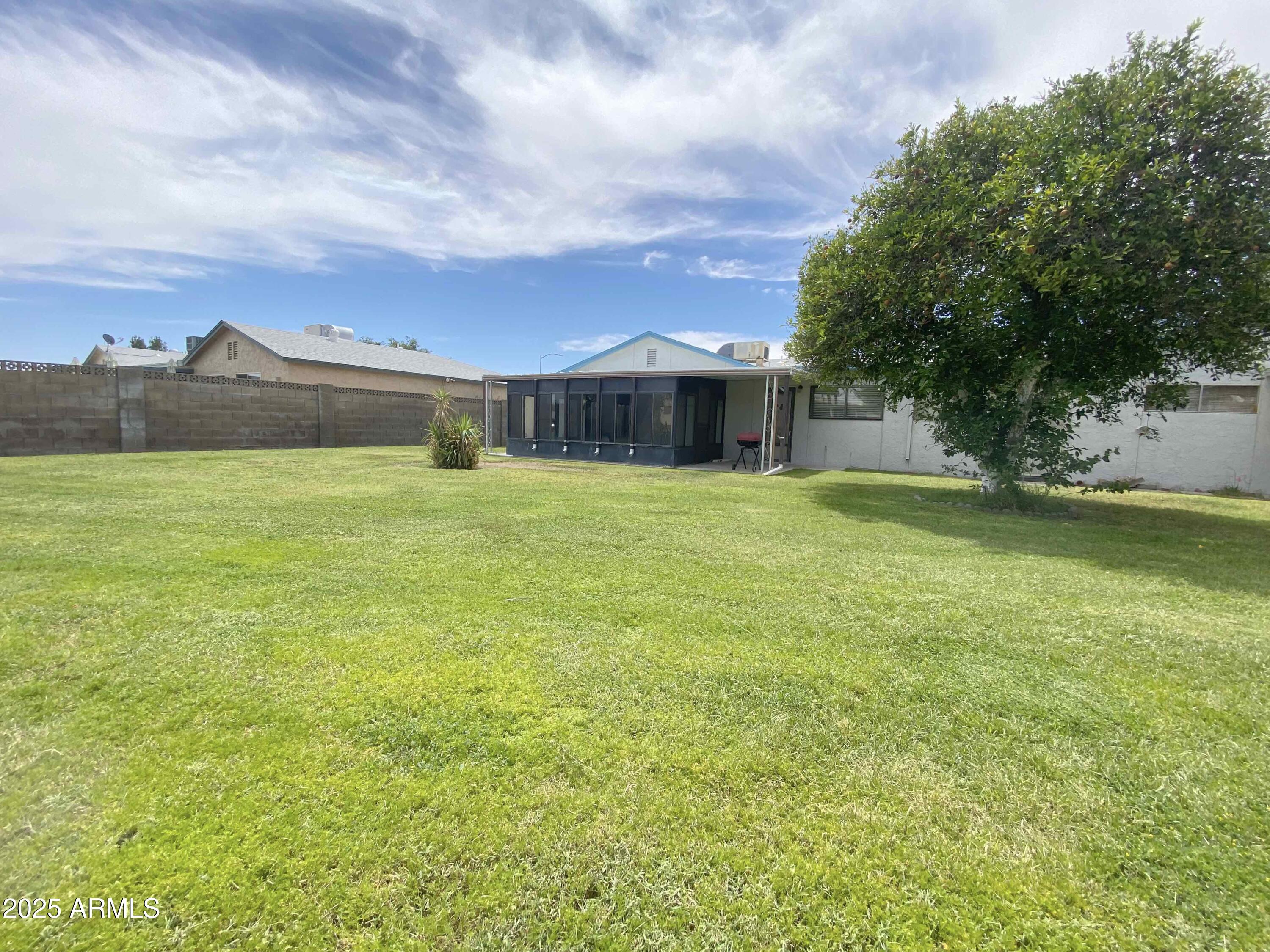 10417 North 95th Drive, Unit B Peoria, AZ 85345 - Photo 16 of 18 a view of a large pool with an outdoor space and seating area