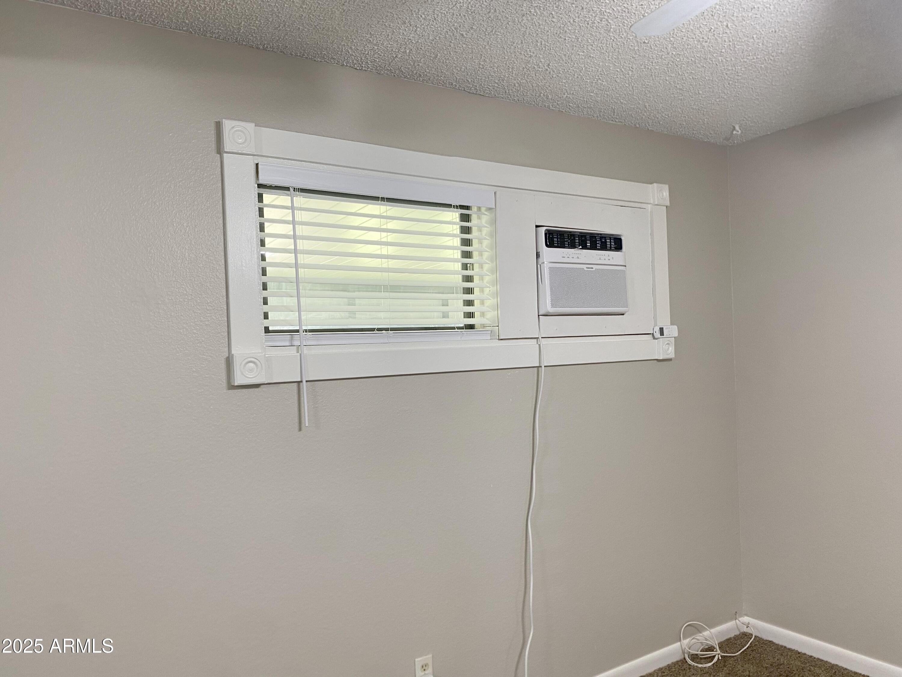 10417 North 95th Drive, Unit B Peoria, AZ 85345 - Photo 10 of 18 a view of an empty room with a window