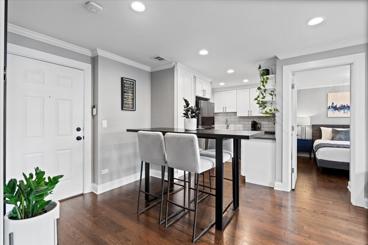 4144 North Sheridan Road, Unit 407 Chicago, IL 60613 - Photo 3 of 19 a view of a dining room with furniture and wooden floor