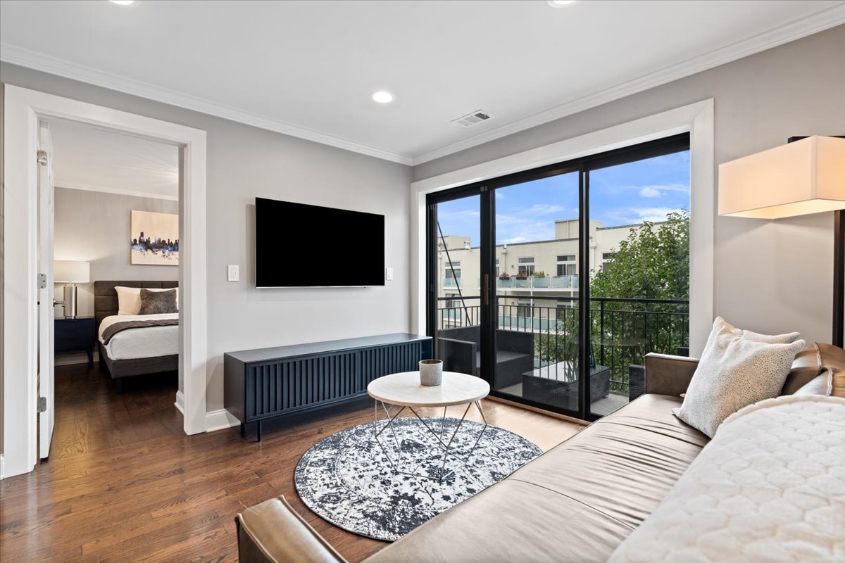 4144 North Sheridan Road, Unit 407 Chicago, IL 60613 - Photo 4 of 19 a living room with furniture and a flat screen tv