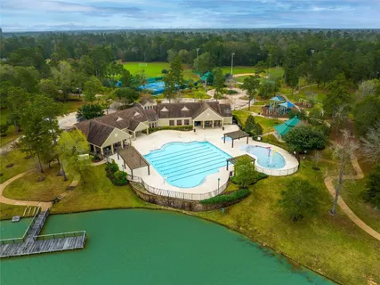 an aerial view of a house with a garden and lake view