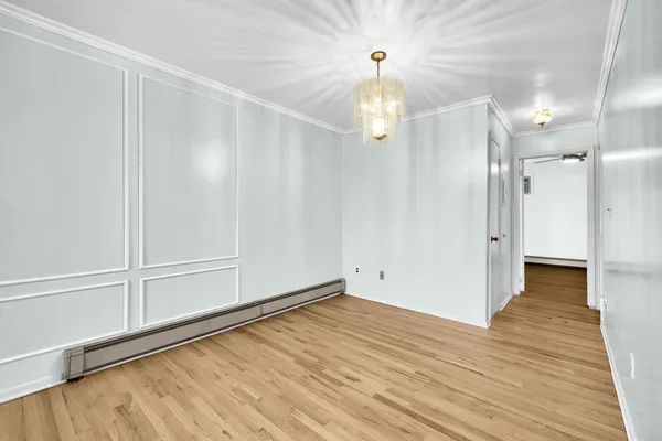 a view of a livingroom with wooden floor and a ceiling fan