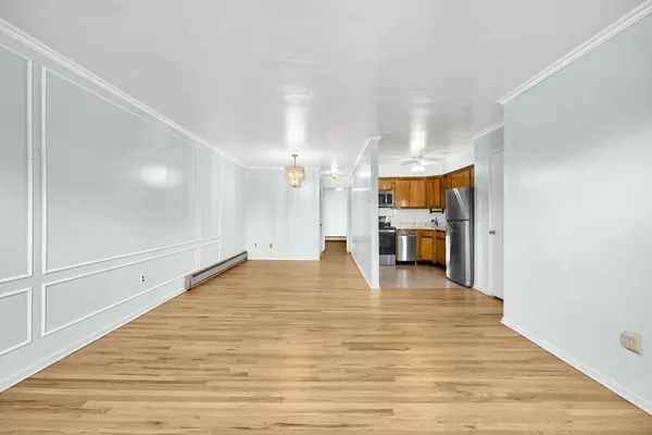 a view of empty room with wooden floor
