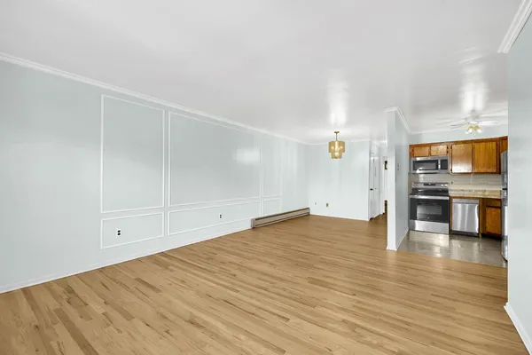 a view of a kitchen with wooden floor and a sink