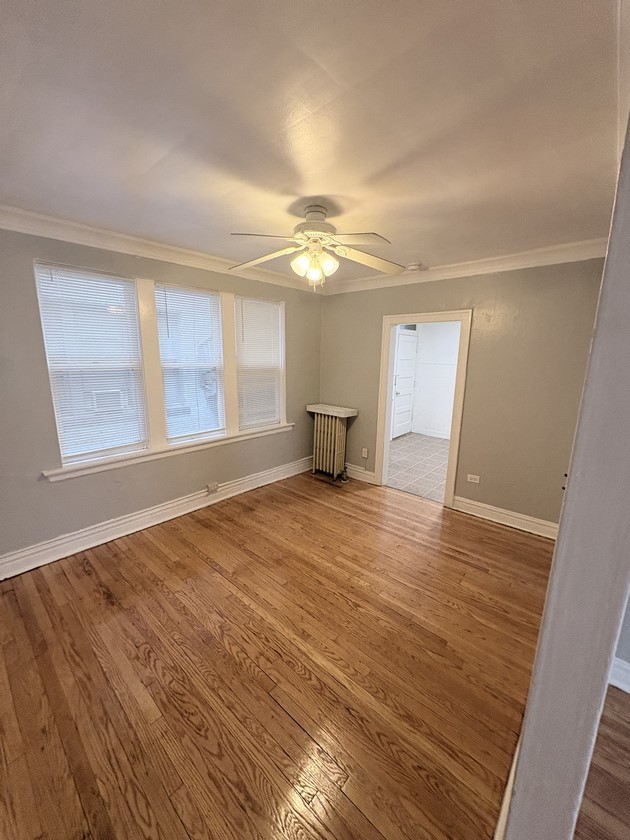 6140 West 19th Street, Unit C2 Cicero, IL 60804 - Photo 11 of 12 a view of empty room with wooden floor and fan