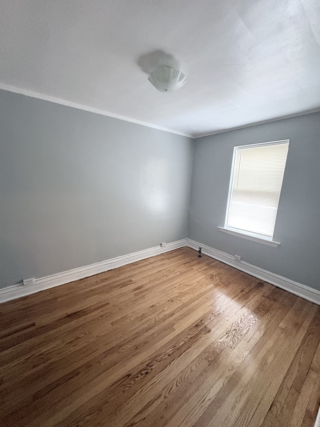 6140 West 19th Street, Unit C2 Cicero, IL 60804 - Photo 12 of 12 a view of empty room with wooden floor and fan