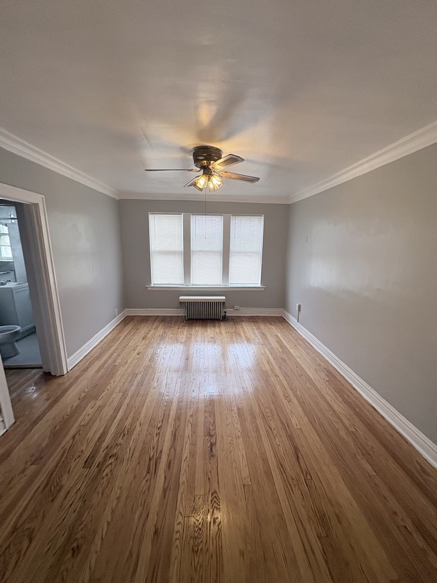 6140 West 19th Street, Unit C2 Cicero, IL 60804 - Photo 9 of 12 an empty room with wooden floor and windows
