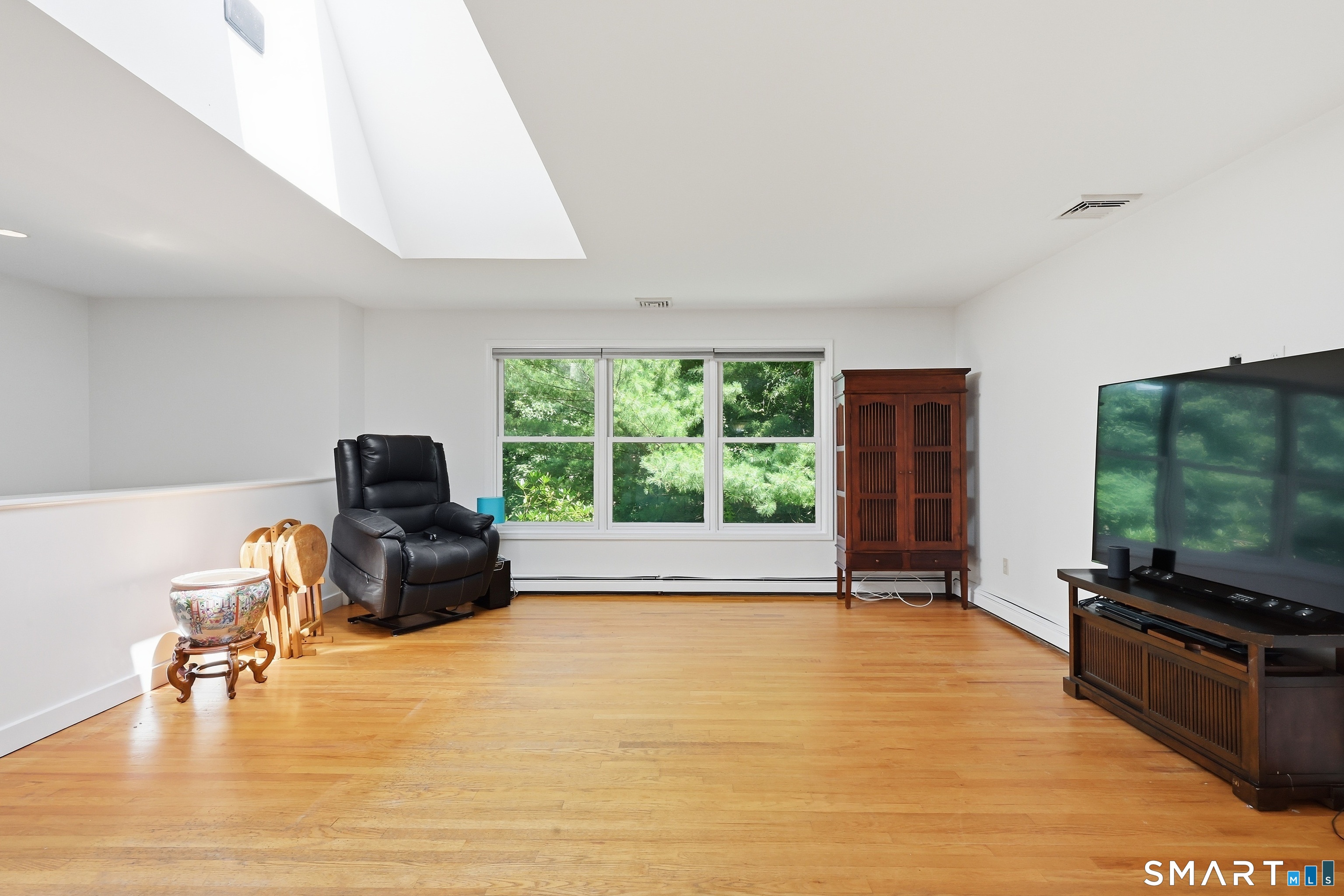 8 Old Bridge Road West New Fairfield, CT 06812 - Photo 11 of 35 Oversized windows and a dramatic skylight fill the room with natural light.