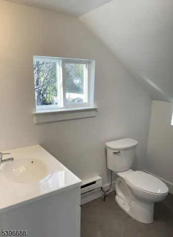 a white toilet sitting next to a bathroom sink