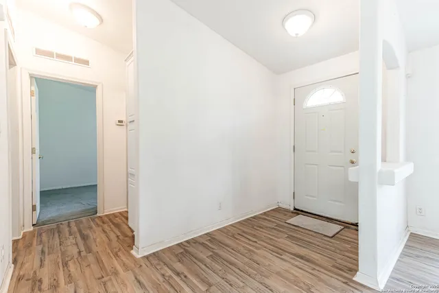 a view of a room with wooden floor