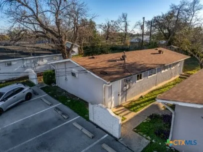 an aerial view of a house with a yard basket ball court and outdoor seating