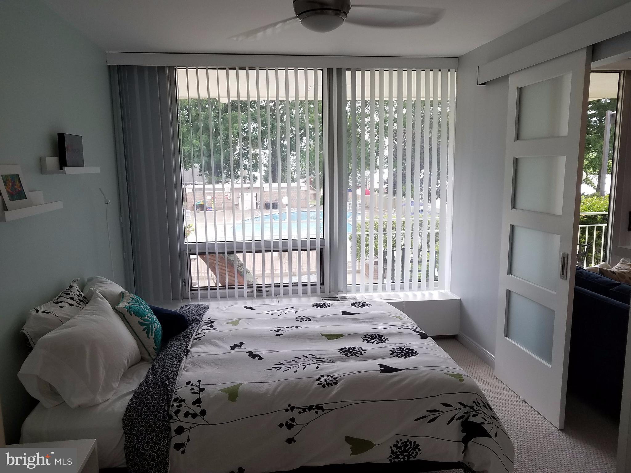 1425 4th Street Southwest, Unit M3 Washington, DC 20024 - Photo 16 of 22 a bedroom with a bed and wooden floor