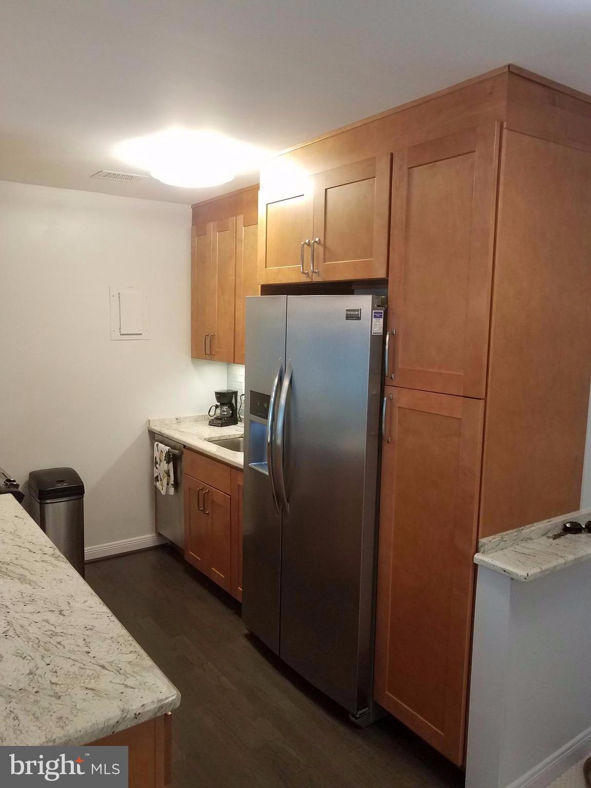 1425 4th Street Southwest, Unit M3 Washington, DC 20024 - Photo 8 of 22 a kitchen with a refrigerator and cabinets