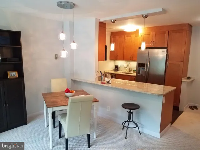 a kitchen with a refrigerator and cabinets